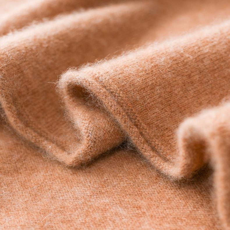 Camel-brown knit fabric detail on a slim fit turtleneck sweater.
