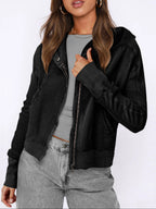 Black waffle-textured zip hoodie with hood and front zipper, worn over a tee.