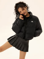 Black short puffer jacket with full-zip front, stand collar, and small chest logo