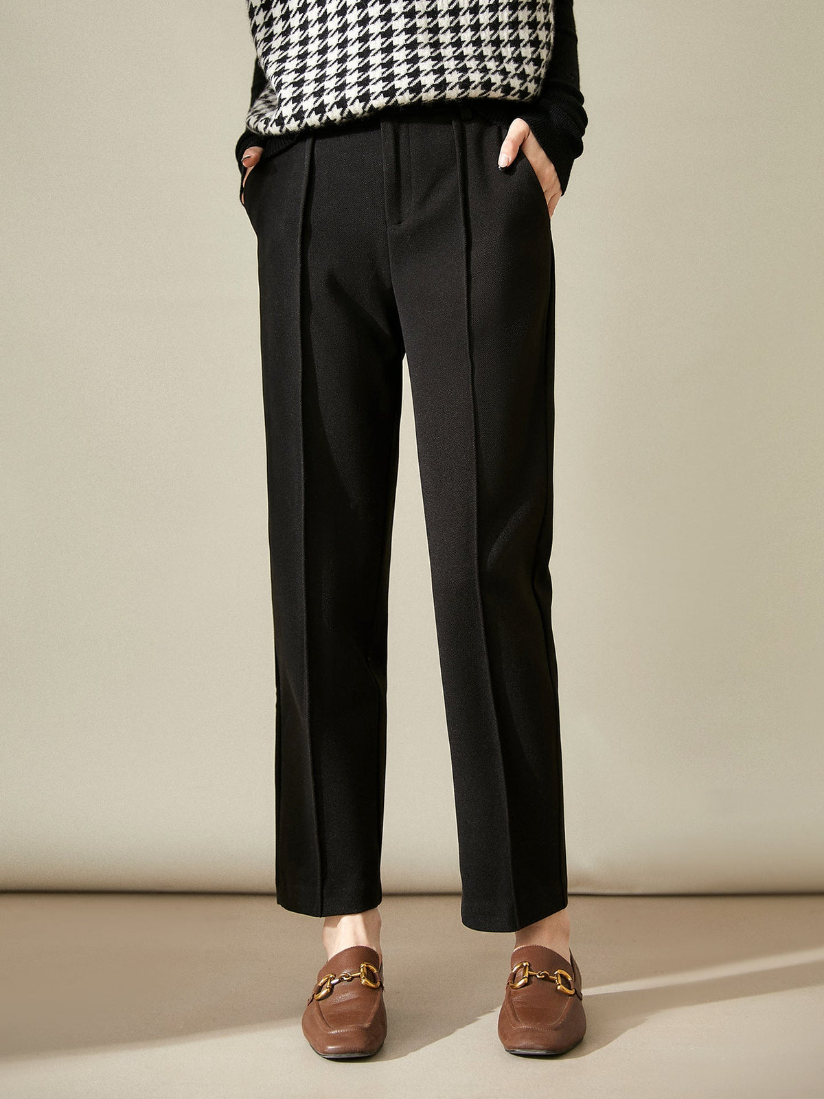 Women’s high-waisted tapered wool-blend trousers, black with belt loops and ankle-length hem