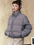 Gray short puffer jacket in a structured puffer silhouette with full-zip front