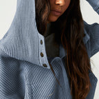 Close-up of blue waffle hoodie hood with dark buttons and knit texture.