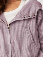 Lavender waffle hoodie with zip front and eyelet-style hood toggles, close detail.