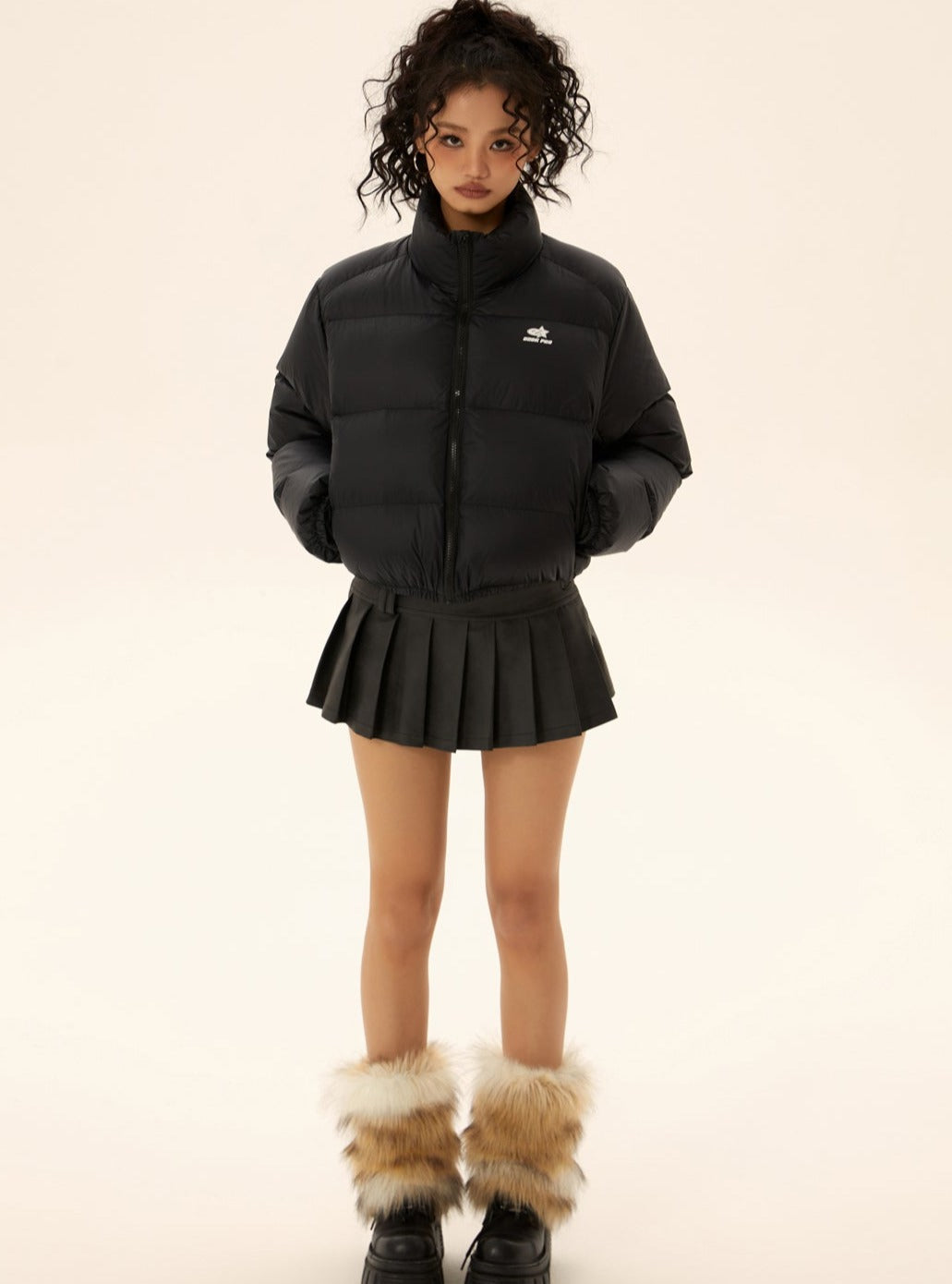 Black short puffer jacket with full-zip front and small chest logo