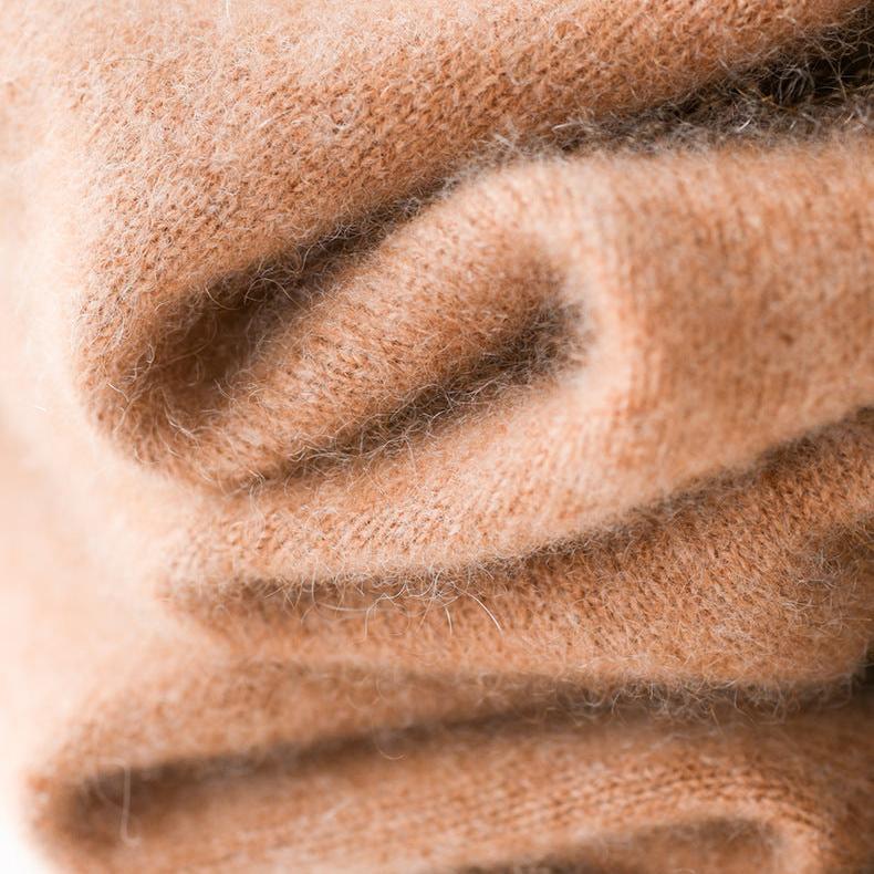 Knit texture close-up of camel-beige turtleneck sweater