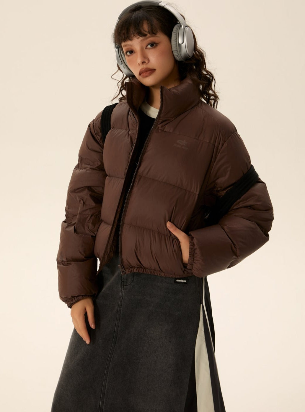 Brown short puffer jacket with zip front and stand collar, padded sleeves