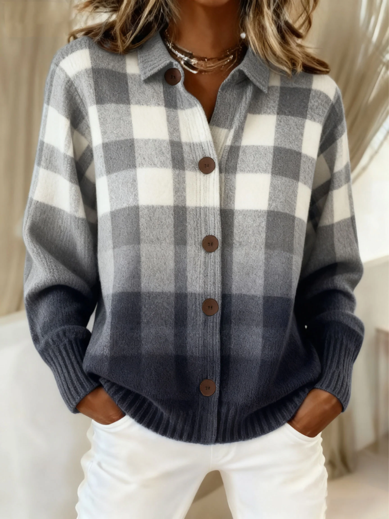 Gray-and-white checkered knit blouse with collar and button front with dark buttons.