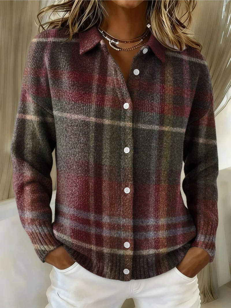 Dark plaid knit blouse with pointed collar and button front with white buttons.