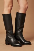 Dark black classic cowboy boots, pull-on style with stacked heel and stitching