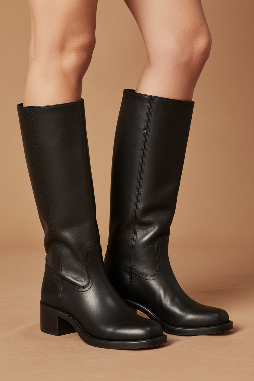 Dark black classic cowboy boots, pull-on style with stacked heel and stitching