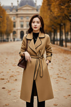 Beige wool coat with black-trim collar, tie-belt waist, and long sleeves