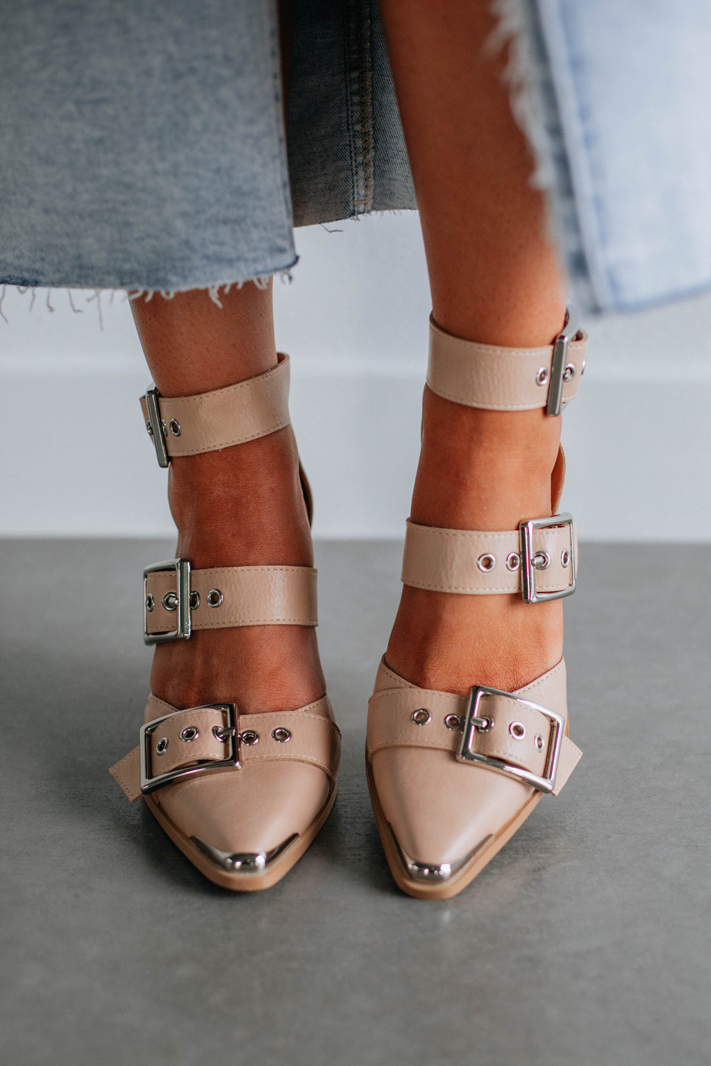 Beige heeled sandals with double ankle straps and silver buckles