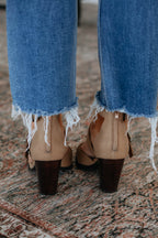 Tan heeled mules from back: block heel and adjustable ankle strap buckles