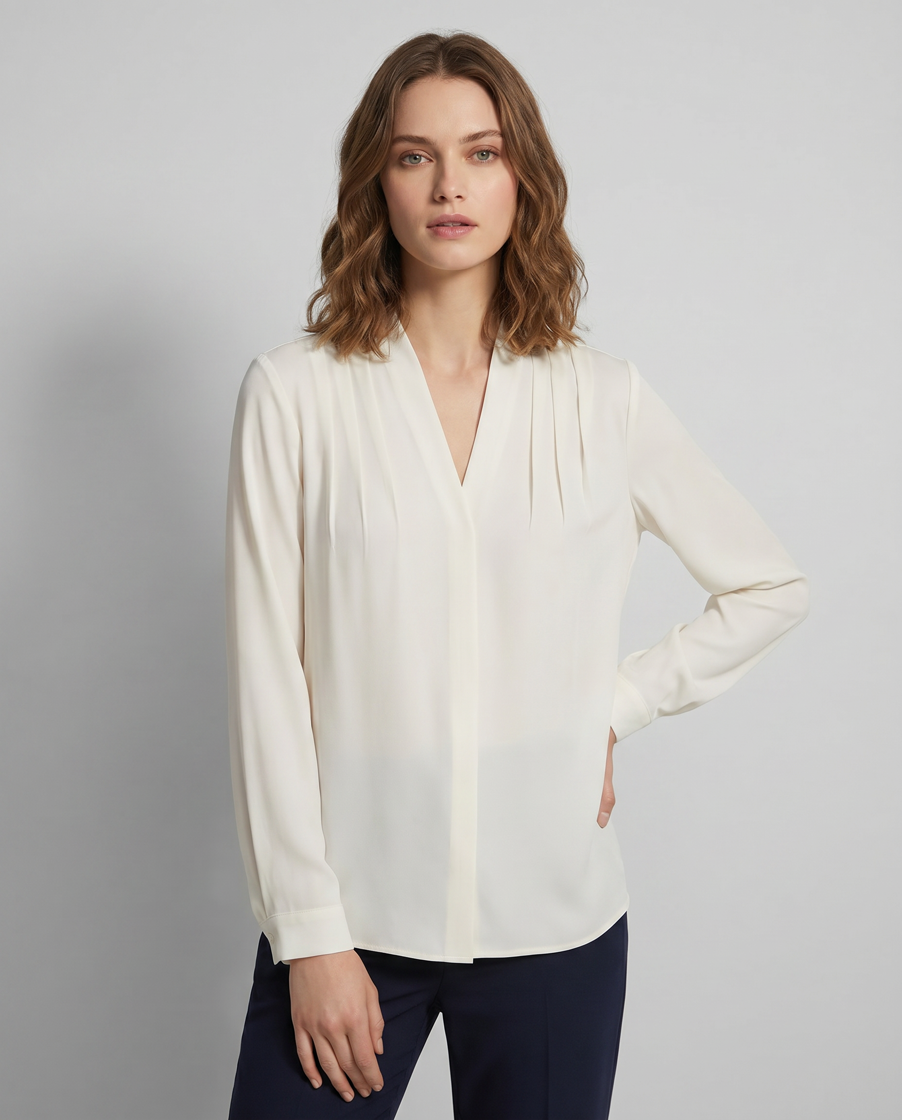 Ivory V-neck blouse with pleated puff sleeves and defined waist