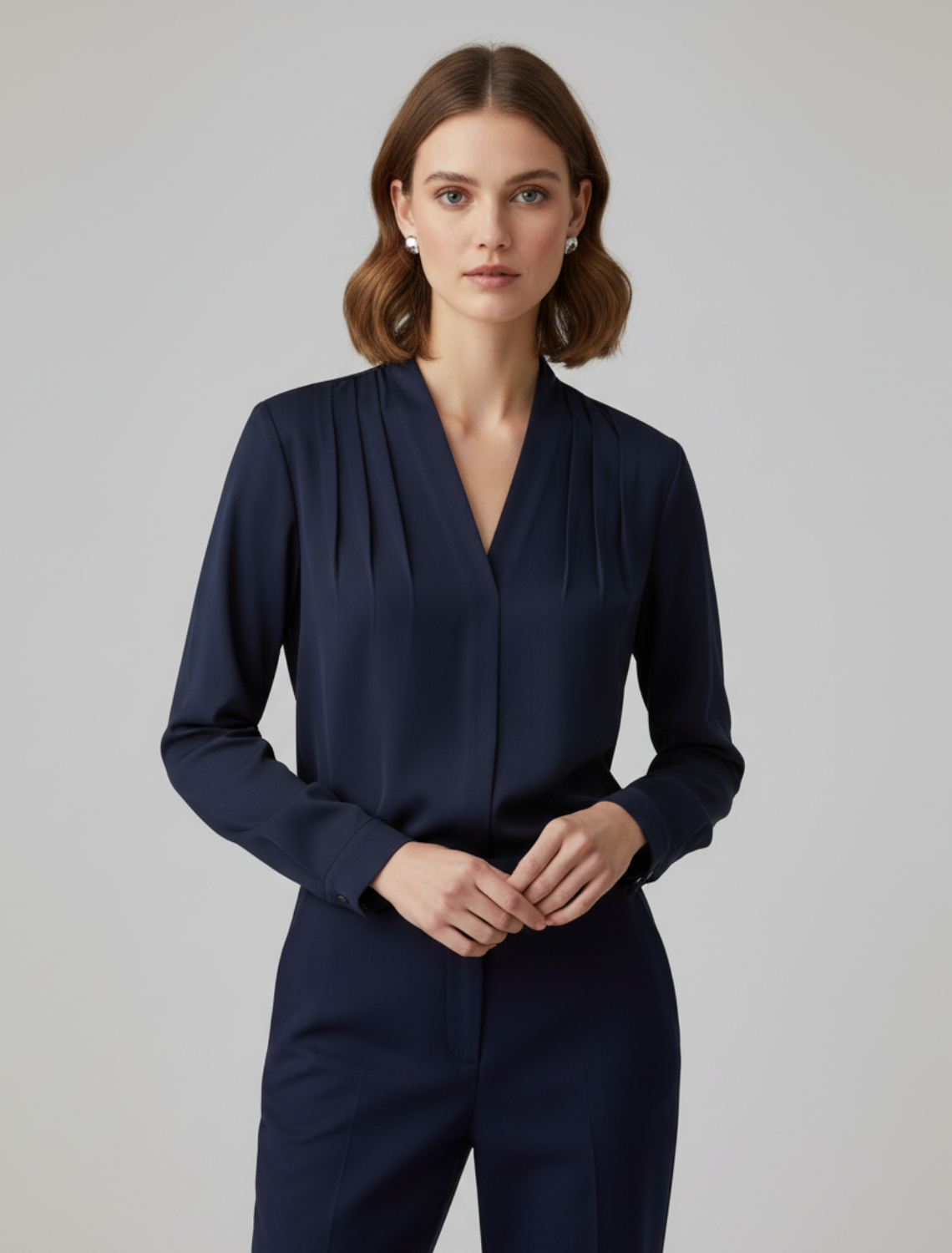 Navy V-neck blouse with long puff sleeves and tailored defined waist