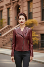 Crimson red leather moto jacket with stand collar and zip-front, front view on hanger