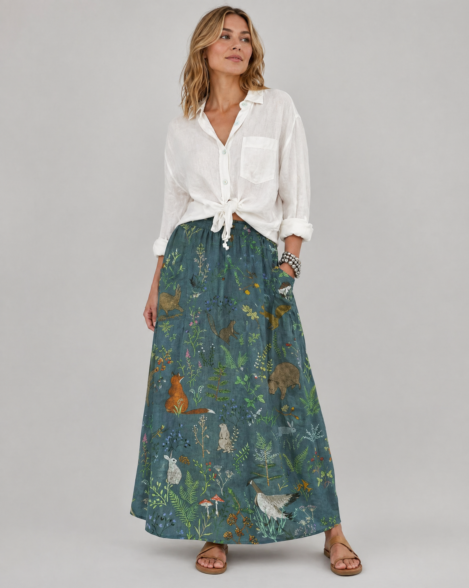 Green A-line pocket skirt with animal-and-floral print, full-length front view.