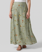 Sage green floral maxi skirt with gathered waist and pleated A-line shape