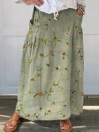 Sage green floral skirt with side pockets and linen-like texture