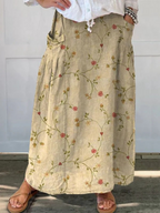 A-line pocket skirt side view with retro floral vine print and pleated front