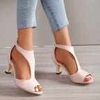 Pink open-toe heeled sandals with ankle strap and mid-height block heel