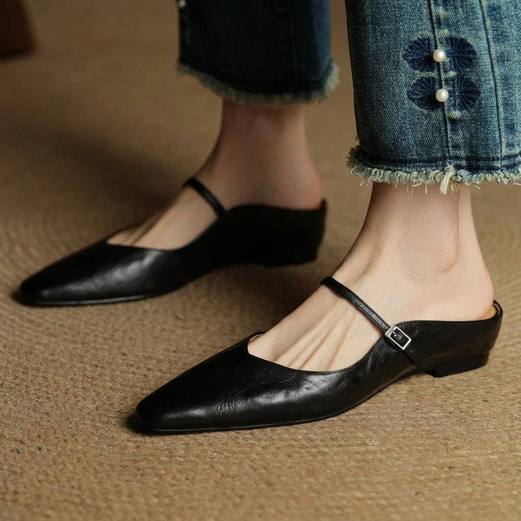 Black orthopedic leather mules with slingback strap and square buckle detail
