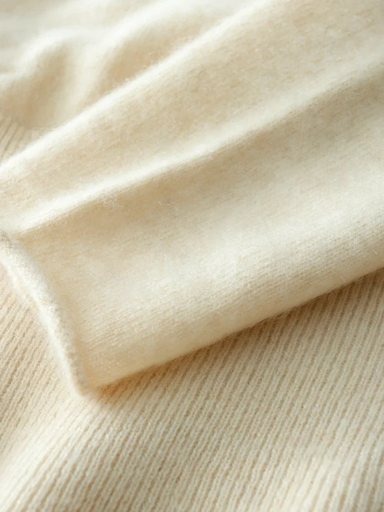 Light beige knit sweater hem with ribbed edge and layered fold detail