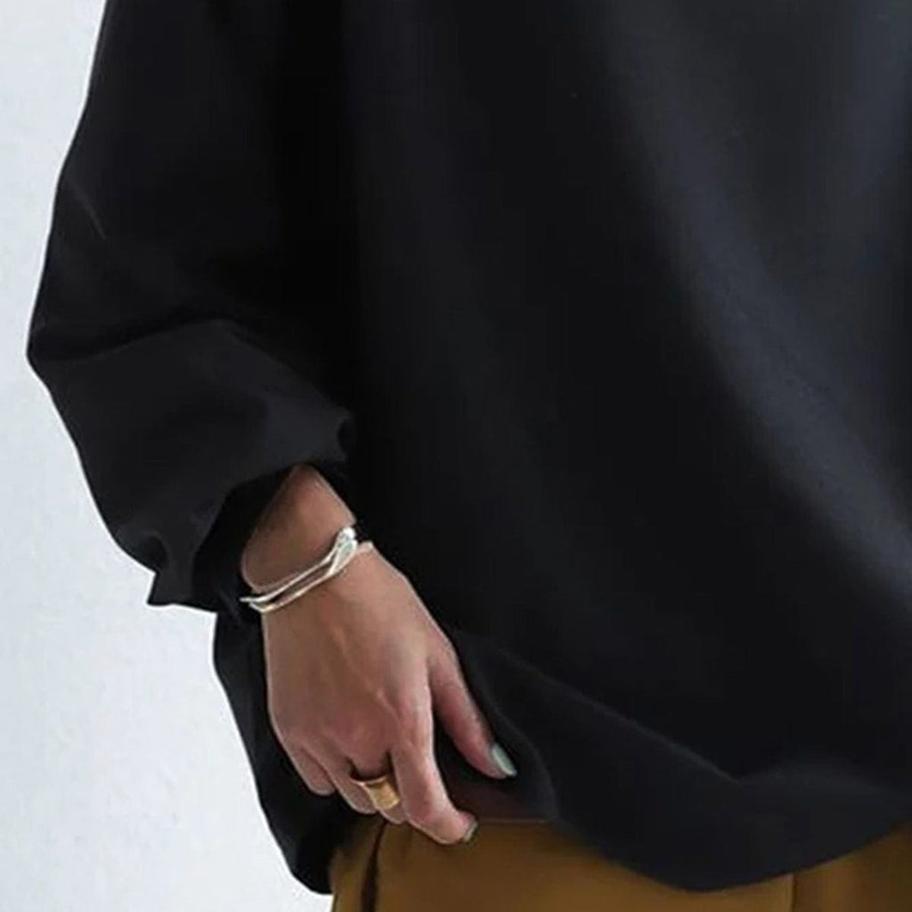 Black high-neck casual top sleeve with relaxed cuff and draped fabric