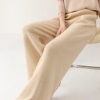 Women’s wide-leg knit pants in cream, close-up of fabric drape across the leg