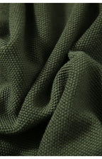 Dark green knit fabric swatch with textured pattern for cardigan.