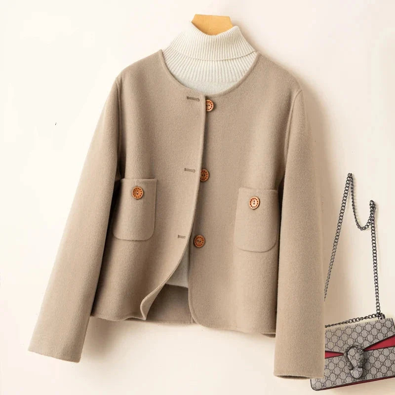 Light beige button-front jacket with ribbed high collar and two patch pockets.