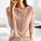 Blush pink asymmetrical button-front knit sweater with long sleeves and ribbed cuffs