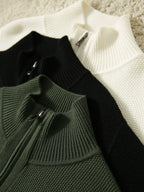 Zip-up knit cardigans in black, ivory, and dark green with front zippers.