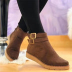 Women’s brown ankle boots with two buckle straps and low cushioned sole