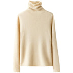 Ivory slim fit turtleneck knit sweater with long sleeves and ribbed collar.