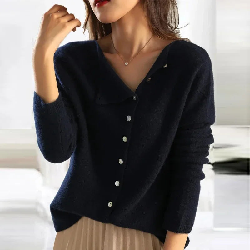 Navy asymmetrical knit sweater with V-neck, front buttons, and three-quarter sleeves