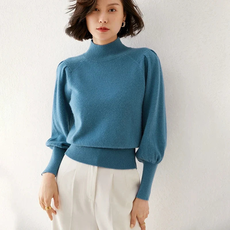 Blue merino turtleneck sweater with puff sleeves and ribbed neckline