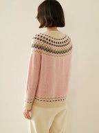Pink fair isle knit sweater from back view with patterned yoke across shoulders