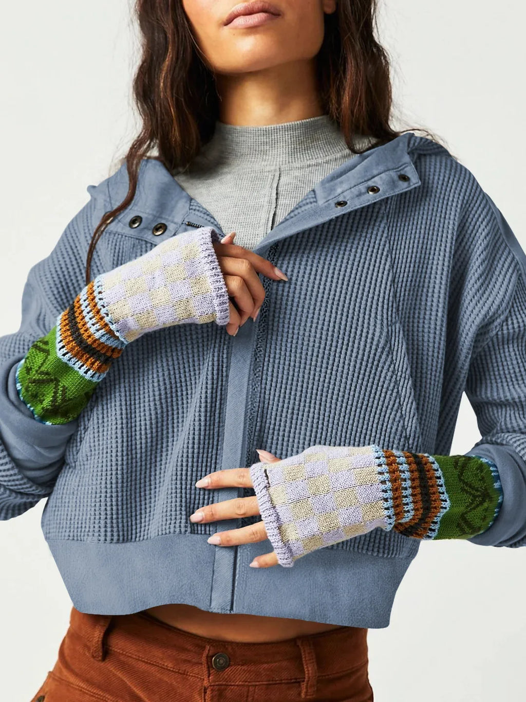 Blue waffle knit zip-up hoodie with button placket and front pockets.