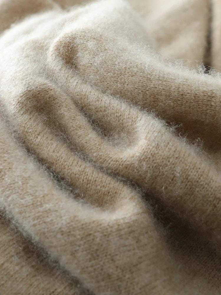 Close-up of beige knit sweater fabric with visible knit ridges and cozy texture