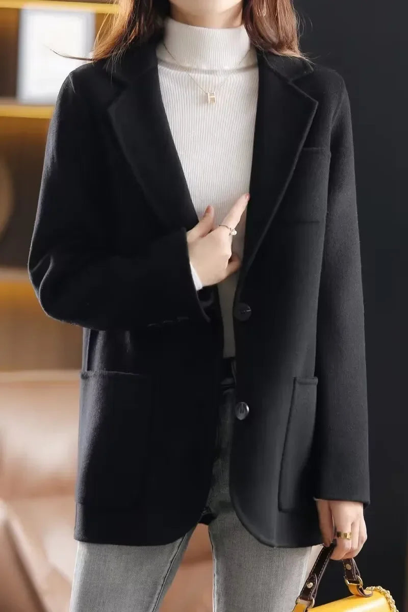 Black wool blazer, notched lapel, single-breasted button front, side flap pockets
