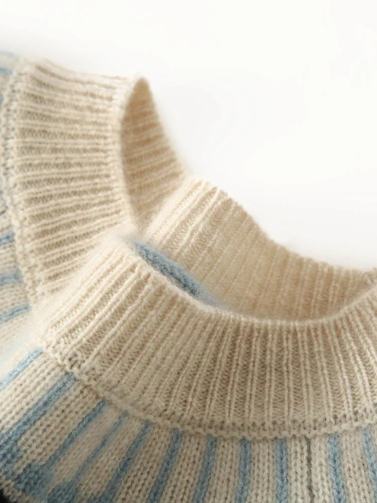 Mock neck rib collar on cream Fair Isle sweater with sky blue stripe detail