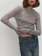 Grey crewneck knit sweater with long sleeves, ribbed cuffs, and fitted hem