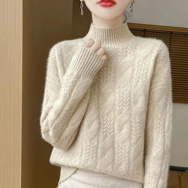Cream cable knit mock neck sweater with raised cable pattern and ribbed collar cuffs.