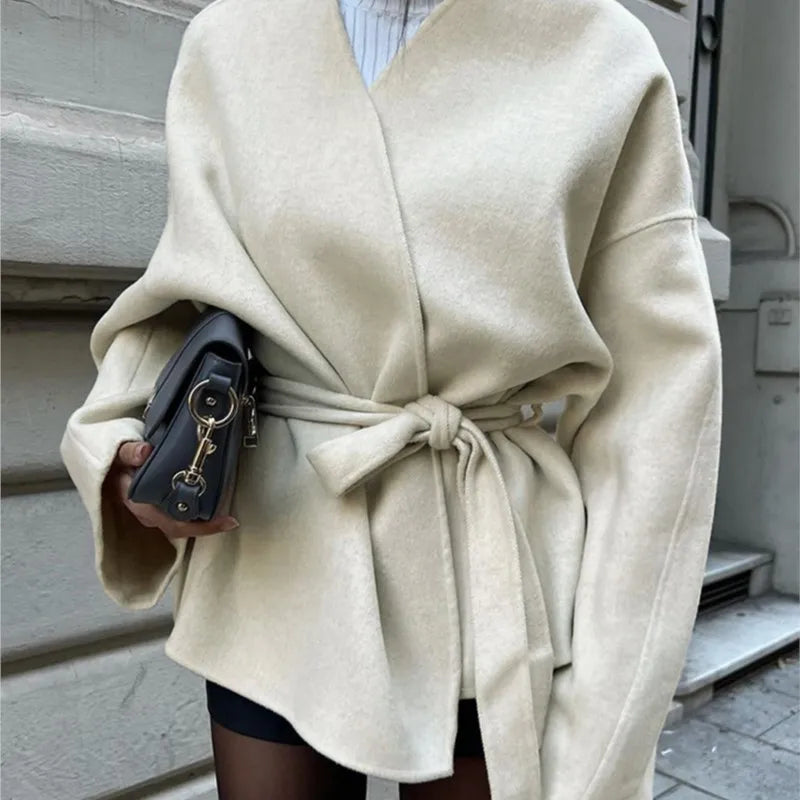 Ivory wrap coat with long sleeves and tied waist sash