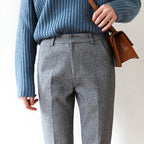 High-waisted gray wool-blend trousers with belt loops, front pleat, and cuffed straight legs