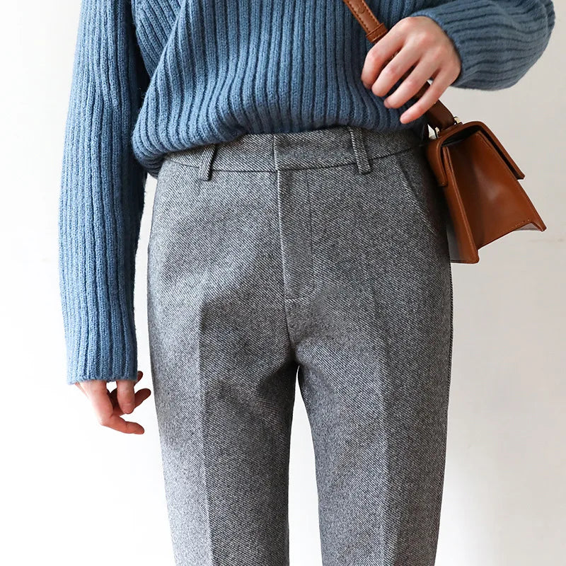 High-waisted gray wool-blend trousers with belt loops, front pleat, and cuffed straight legs