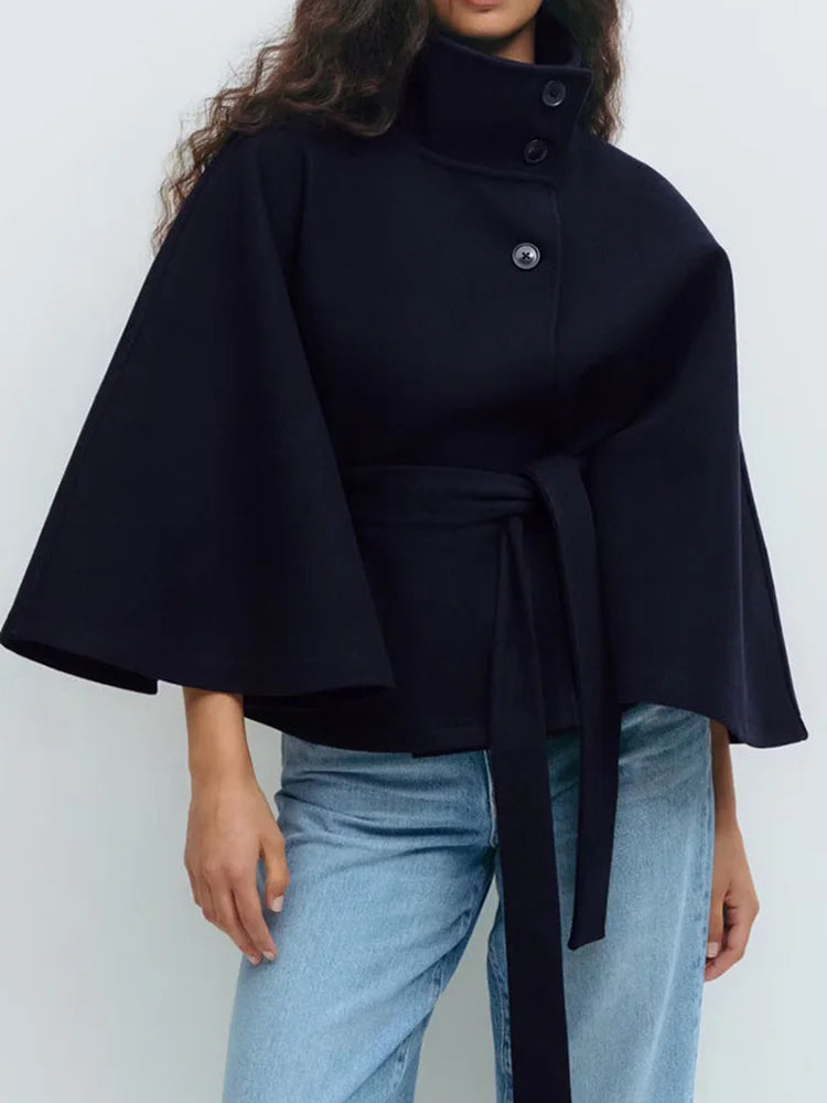 Navy wool-blend cape coat with stand collar and snap buttons; belted waist
