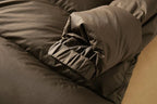 Long down puffer parka with hood, dark brown quilted fabric with gathered sleeve
