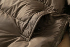 Long down puffer parka with hood, dark brown front with angled pocket and seam